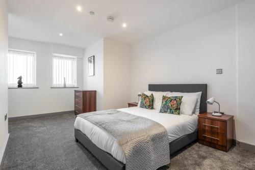 a bedroom with a large bed and a night stand at Contemporary 1 Bedroom Apartment in Central Hull in Hull