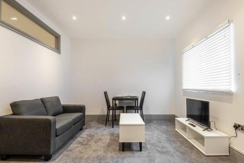 a living room with a couch and a table at Contemporary 1 Bed Budget Apartment in Darlington in Darlington