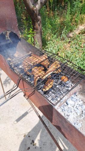 a grill with a bunch of food on it at САЙ-SAI in Arslanbob