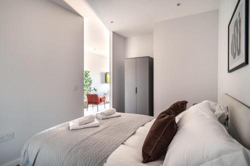 a bedroom with a large bed with two pillows at Modern & Spacious 2 Bed Apartment in Waterloo Liverpool in Waterloo