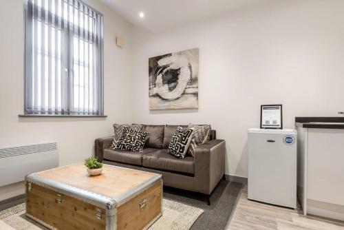 a living room with a couch and a coffee table at 1 Bedroom Budget Apartment in Central Doncaster in Doncaster