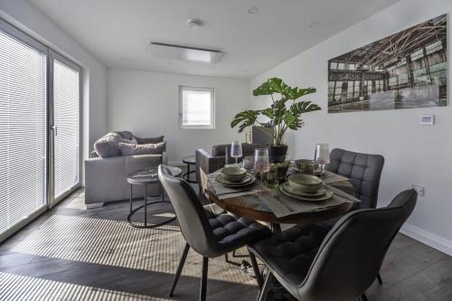 a dining room with a table and chairs at Stylish and Bright 2 Bed Apartment in Ashford in Ashford