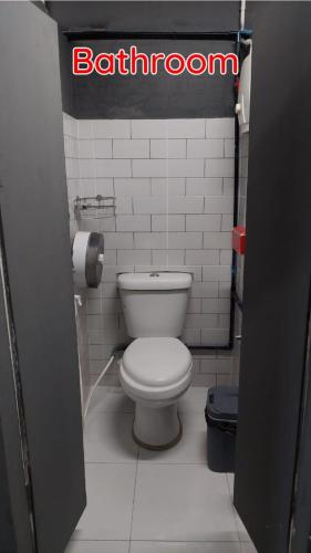a bathroom with a white toilet in a stall at Dormsin Chill in Phi Phi Islands