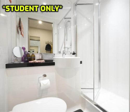 a bathroom with a shower and a toilet and a sink at Student Only Zeni Ensuite Rooms Belfast in Belfast