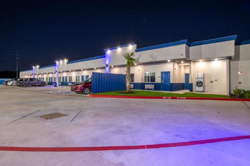 a large building with blue lights in a parking lot at Azul Inn in Houston