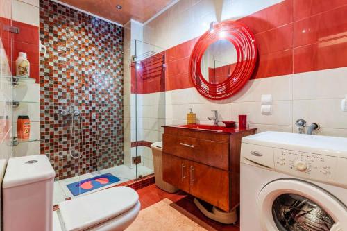 a bathroom with a washing machine and a washer at Athens Strawberry Hideaway - City Chic Retreat in Athens