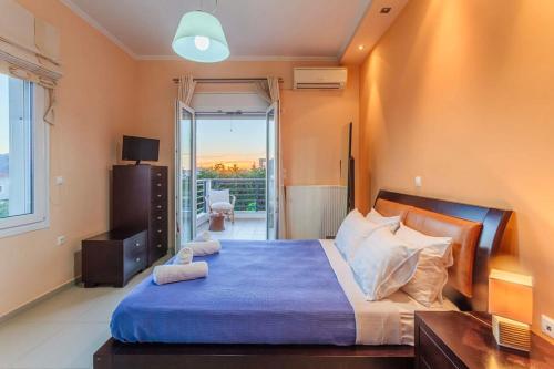 a bedroom with a large bed and a balcony at Navarino Captains Villa - Lux Private Pool Retreat in Marathopolis