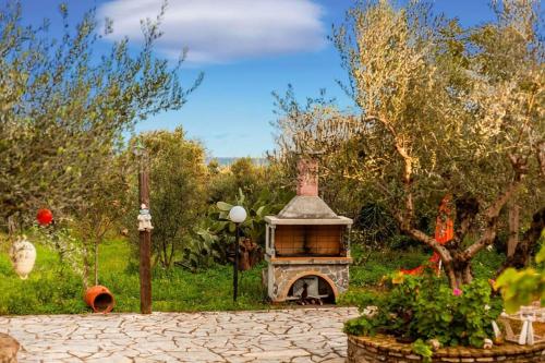 a garden with a brick oven in a yard at The Fairytale House Seaside Retreat in Chrani