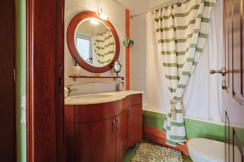 a bathroom with a sink and a mirror at Verga Sunset Villa - Ilia Seascape Private Retreat in Mikrá Mandínia