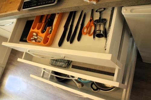 a kitchen cabinet drawer filled with lots of tools at Rachele Guest House La Spezia in La Spezia