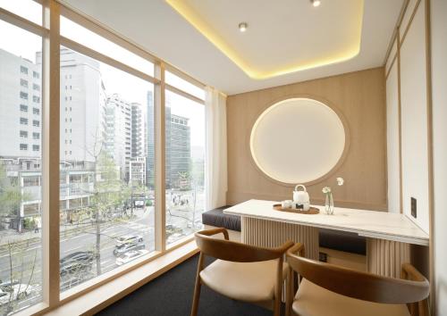 a room with a sink and a large window at UH Suite Seoul Deoksugung in Seoul