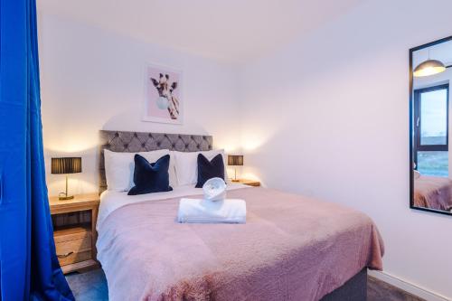 a bedroom with a large bed and a mirror at Beautiful Manchester Home Sleeps 9 by PureStay Short Lets in Manchester