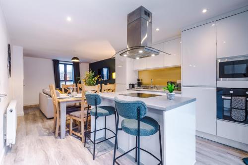 a kitchen and dining room with a table and chairs at Stunning Manchester House Sleeps 10 with Parking by PureStay - Short Stays & Accommodation in Manchester