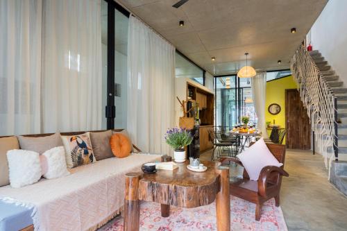 a living room with a couch and a table at Min's House Hoi An - 4 bedroom villa, pool in Hoi An