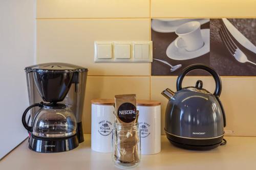 a kitchen counter with a coffee maker and a blender at Mani Panoramic Views - Private Sunny Retreat in Levktron