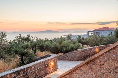 a stone staircase leading up to a house with lights at Mani Panoramic Views - Private Sunny Retreat in Levktron