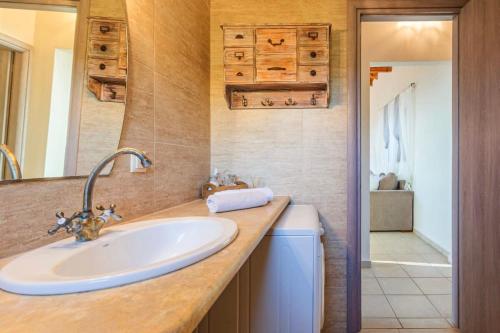 a bathroom with a sink and a shower at Mani Panoramic Seaviews - Luxury Summer Haven in Lévktron