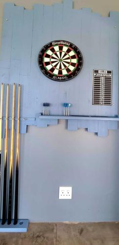 a dart board on a wall with a dartboard on it at The Farmstead in Cannon Rocks