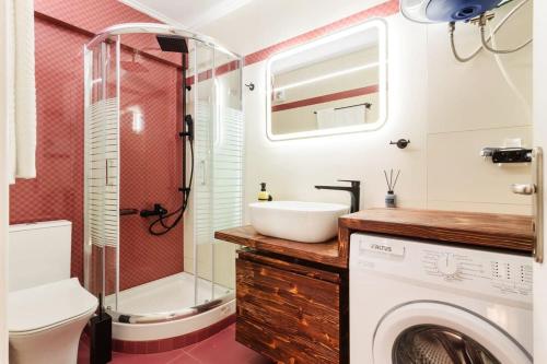 a bathroom with a sink and a washing machine at Kalamata Lime Studio - Urban Cozy Nest in Kalamata