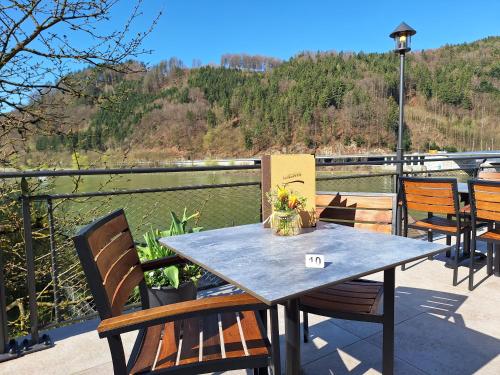 a table and chairs on a deck with a view at Gasthof zur Donaubrücke in Ardagger Markt