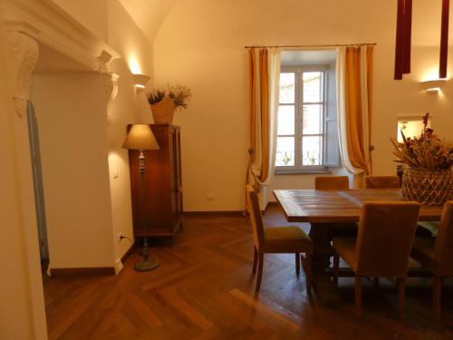 a dining room with a table and chairs and a window at Scappo in Umbria, Residenza Monaldeschi in Orvieto