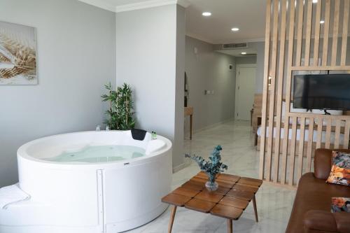 a bath tub in a living room with a tv at Sapanca View Hotel in Sapanca