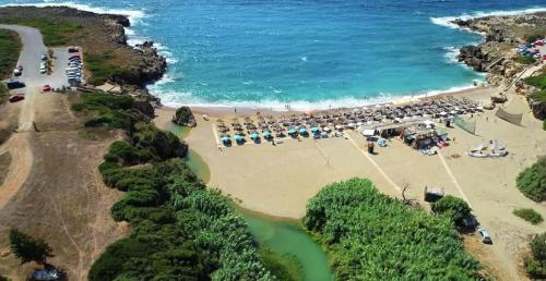 an aerial view of a beach with umbrellas and the ocean at Filiatra Downtown Cozy Retreat - Homely Vibes in Filiatra
