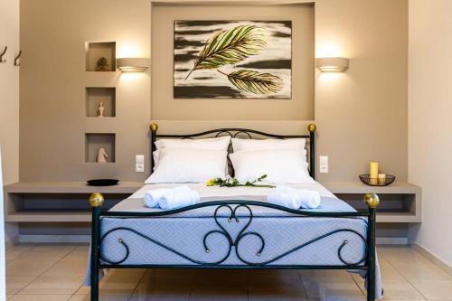 a bedroom with a bed with a painting on the wall at Filiatra Downtown Cozy Retreat - Homely Vibes in Filiatra