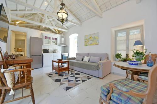 a living room with a couch and a table at A Sea-licious Vacation - Chic & Style in Hydra in Hydra