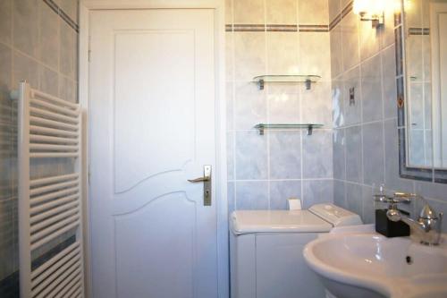 a bathroom with a white toilet and a sink at Schinias Bright Spacious Maisonette-Panoramic View in Marathon