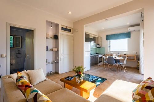 a living room with a couch and a table at Kitries Summer Getaway - Eden Comfy Suite in Kitriaí