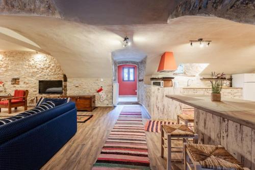 a living room with a blue couch and a red door at Arcadia Getaway - Levidi Sani 11 Studio in Levidhion