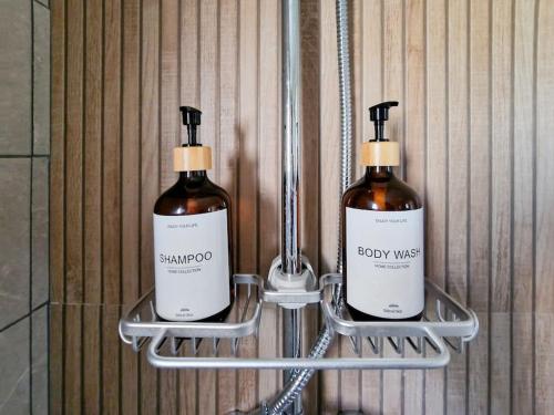 two bottles of soap are hanging on a wall at Cozy Owl's Studio Home in Pýrgos