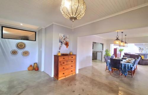 a living room with a table and a dining room at The Farmstead in Cannon Rocks
