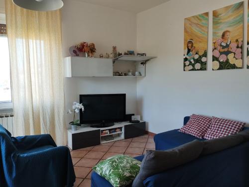 a living room with a couch and a flat screen tv at Casa Coiri in Cairo Montenotte