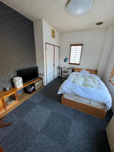 Postel nebo postele na pokoji v ubytování Ryokan Iwasawasou