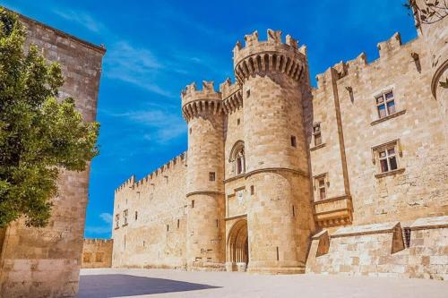 a large castle with a tower at Knights Golden Loch - Rhodes Unique Getaway in Rhodes Town