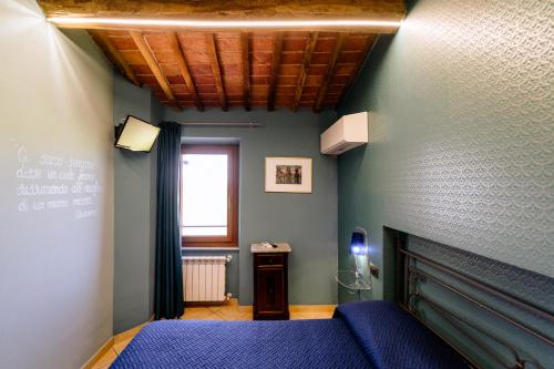 Ένα ή περισσότερα κρεβάτια σε δωμάτιο στο B&B Da Nada Locanda Toscana