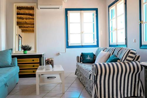 a living room with a couch and a table at Cycladic Bliss - Uncovering Paros Seaview Gem in Drios