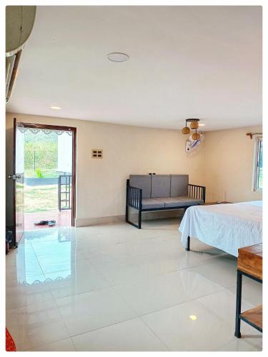 a bedroom with a bed and a couch at Gitanjali Forest Retreat in Bāghmundi