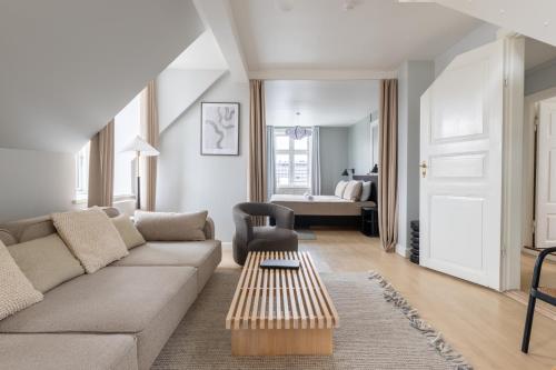 a living room with a couch and a table at Perfect Holiday Homes Near Amager Beach in Copenhagen