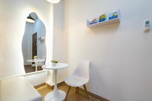 a room with two tables and a mirror at Dorms Bui Vien - Walking street in Ho Chi Minh City