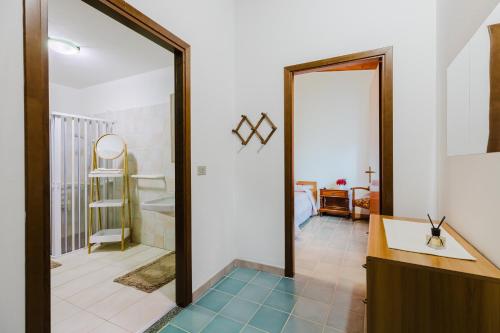 a bathroom with a mirror and a sink at Il Corbezzolo Apartment in Palmas Arborea