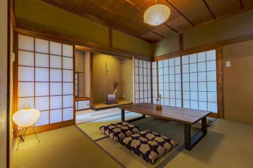 a room with a table and a bench in it at NIPPONIA HOTEL NARA NARAMACHI in Nara