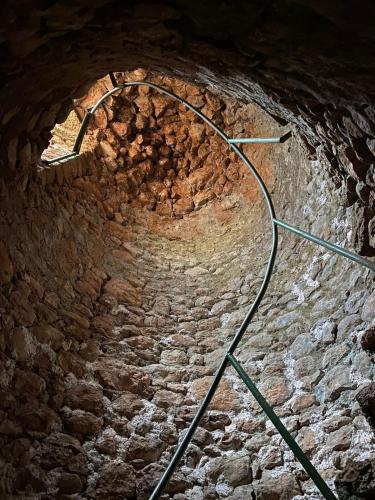 a brick tunnel with a light at the top at Vacation Home Domgjon in Rrëshen