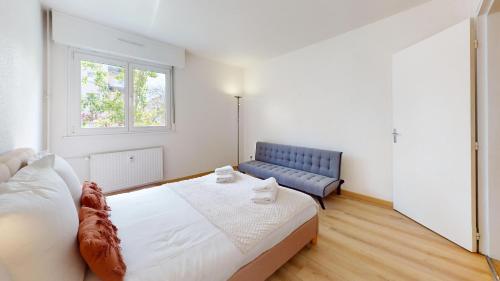 une chambre avec un lit et un canapé bleu dans l'établissement Brasseur, à Colmar