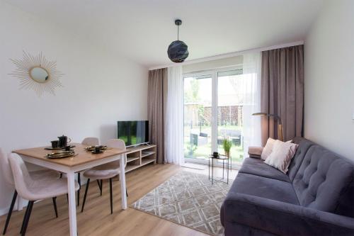 a living room with a couch and a table at Golden Sand - Baltic Line in Gdańsk