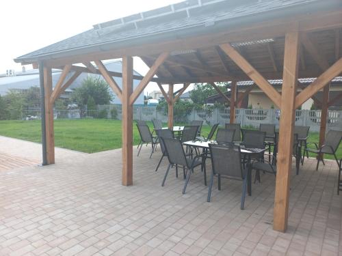 a group of tables and chairs under a pavilion at SielAnka in Uniejow