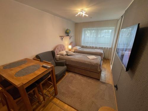 a small room with a bed and a table at Rohuaia 22 Apartment in Rakvere