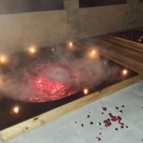 a large tub of meat on a grill with smoke at Hotel ELYSIUM in Irshava